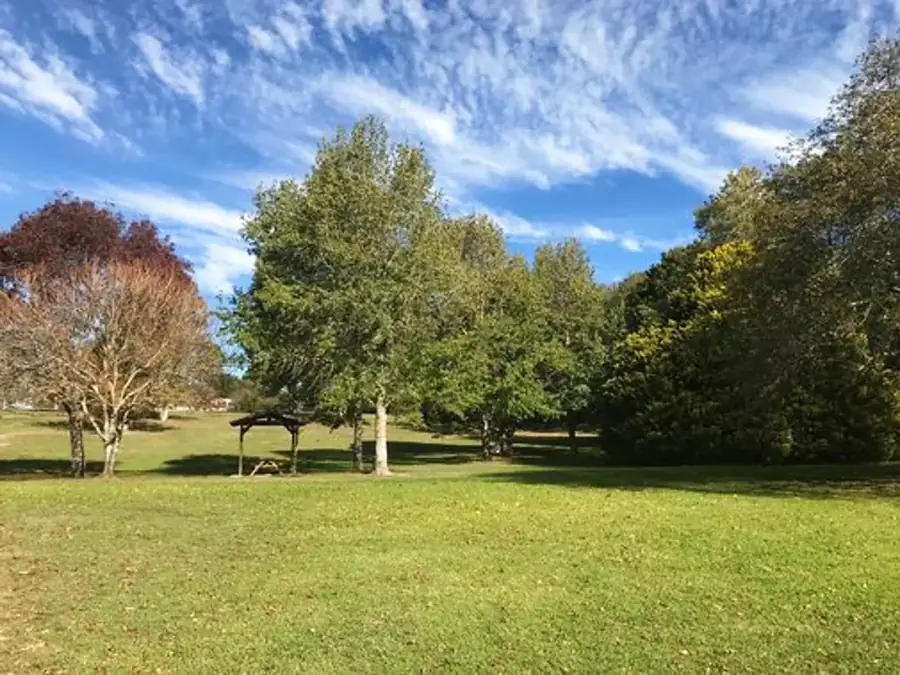 Open lawn and trees at Seymour Park in Moss Vale
